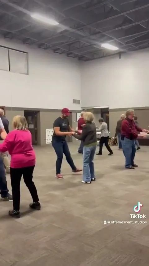 A group line dancing in the hall at Effervescent Studios