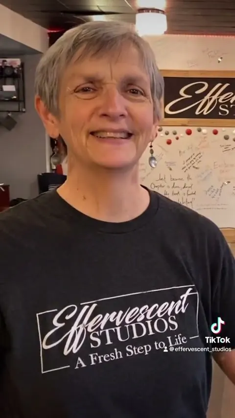 A smiling student in an Effervescent Studios shirt