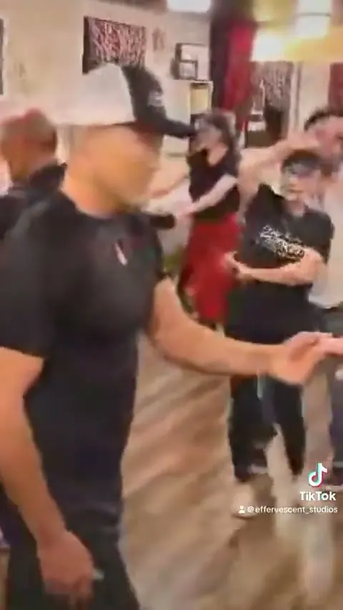 Adults dancing the hustle together at Effervescent Studios